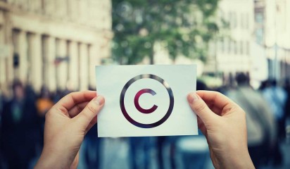 Hands hold paper with copyright symbol