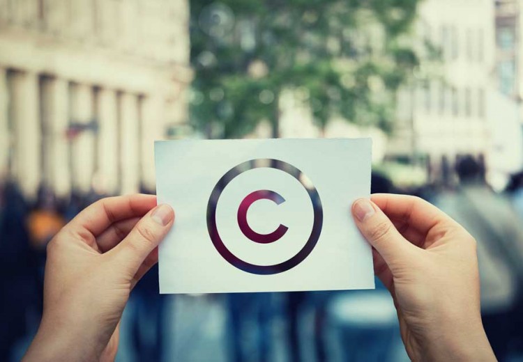 Hands hold paper with copyright symbol